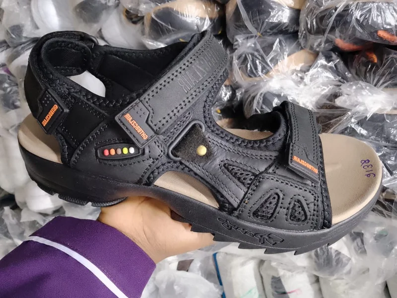 black_leather_sandals_with_orange_accents_2.webp